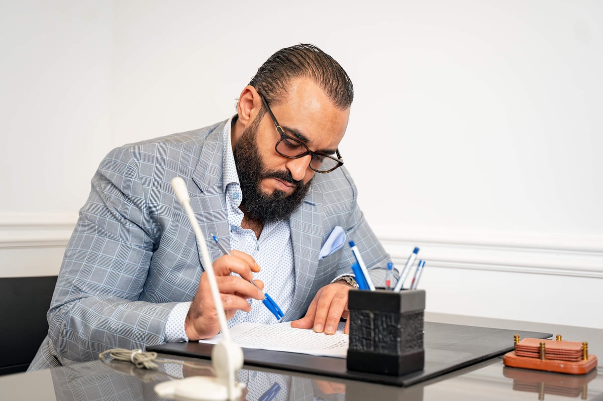 BusinessMan in suit with beard writing notes