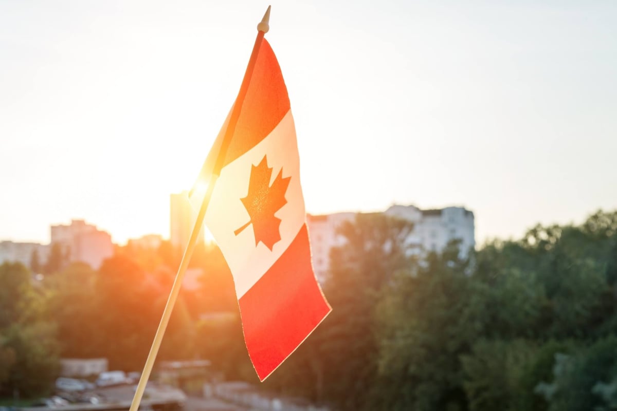 Flag of Canada from window sunset background