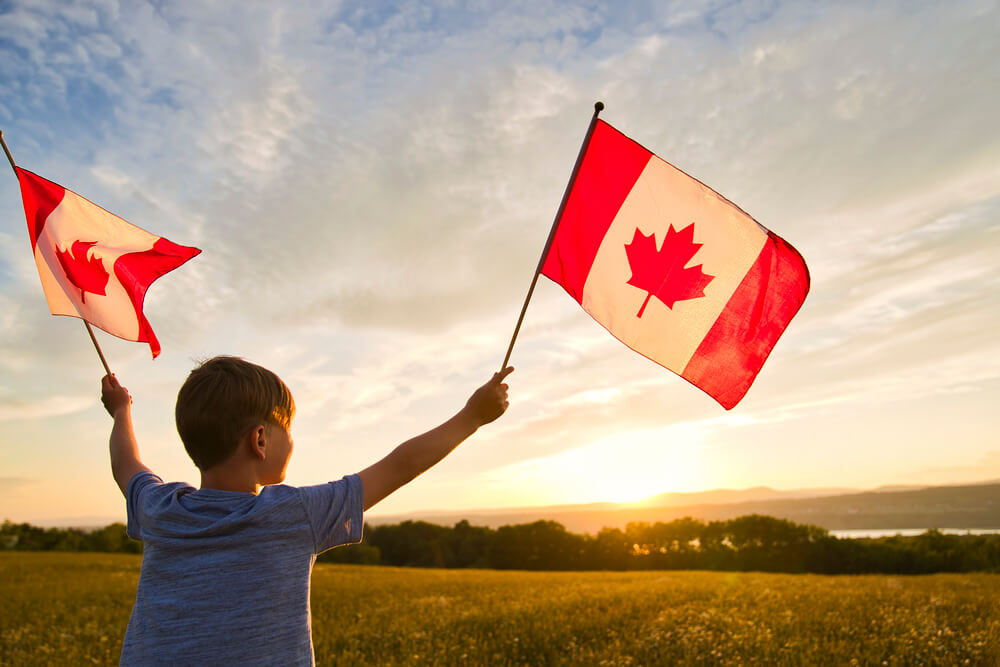 Boy Holding Canadian flags
