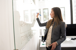 Business Woman writing on Board