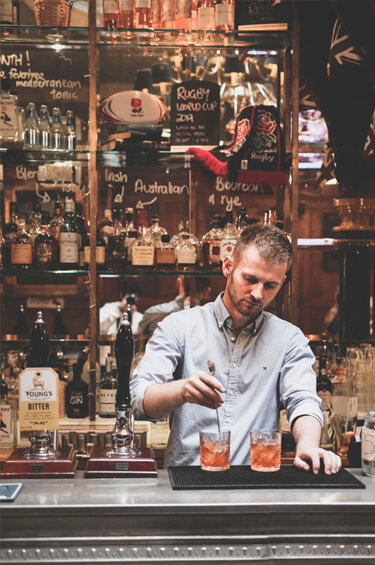 Bartender making 2 drinks