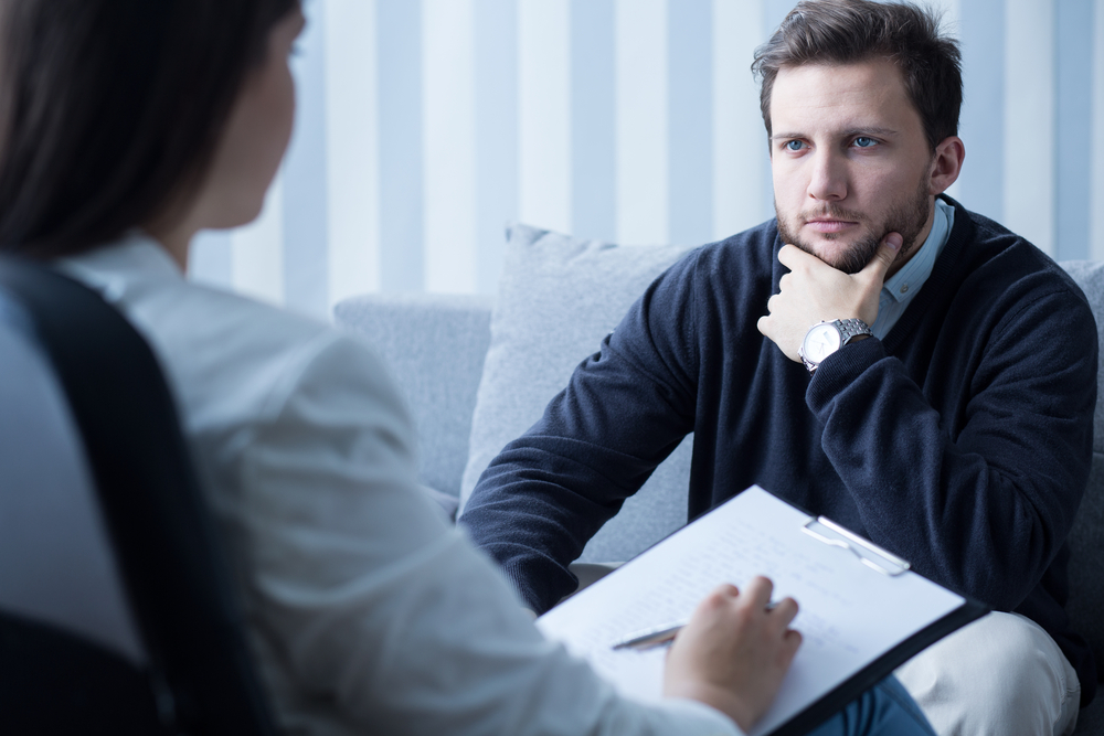 Young man during therapy at psychologists office Young man during therapy at psychologists office